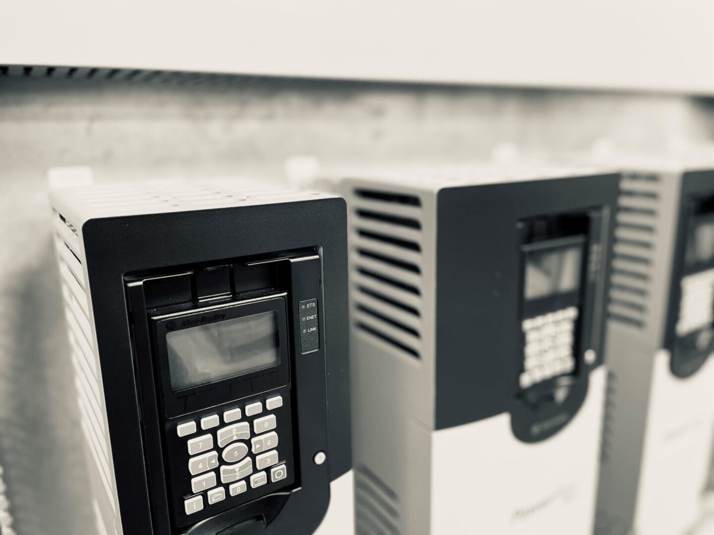 A close up of two electronic machines on the side of a building.