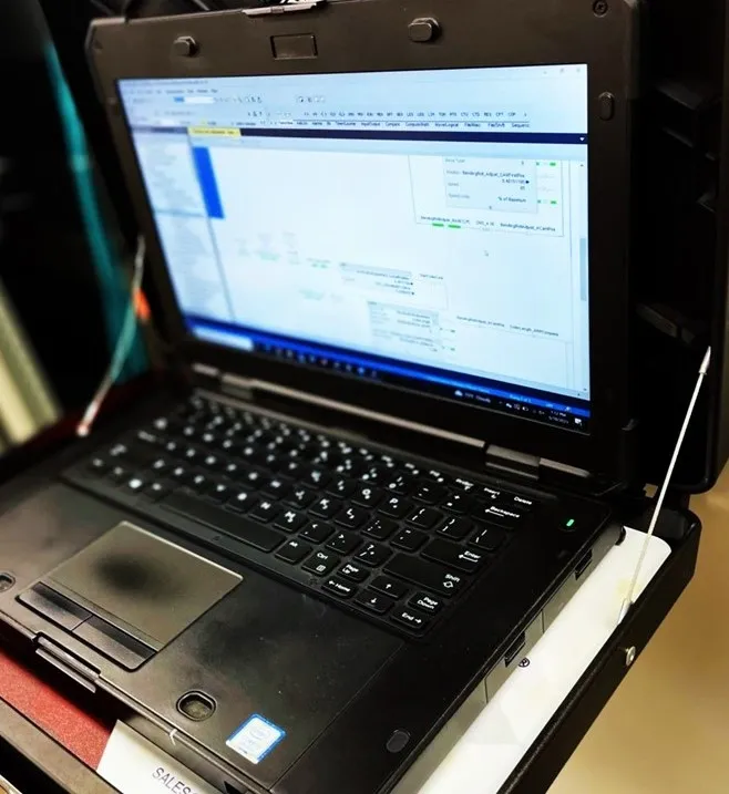 A laptop sitting on top of some books.